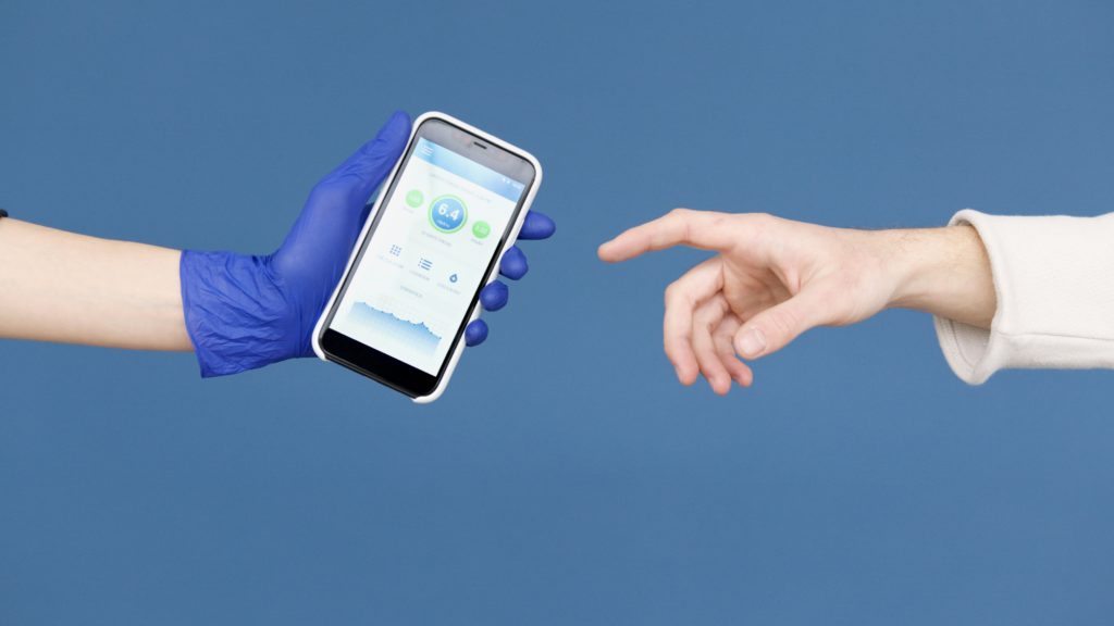 Hand of patient reaching for smartphone with health app offered by hand of doctor wearing blue glove