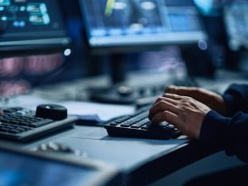 Close Up of a Professional Office Specialist Working on Desktop Computer in Modern Technological Monitoring Control Room with Digital Screens. Manager Typing on keyboard and Using Mouse.